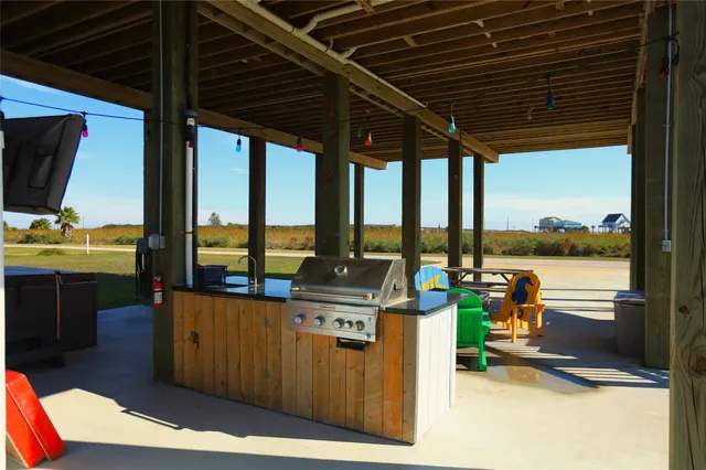 a view of an outdoor kitchen with swimming pool