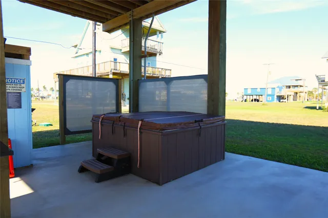 a view of a couches in the patio with a yard