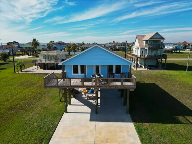 a front view of a house with swimming pool table and chairs