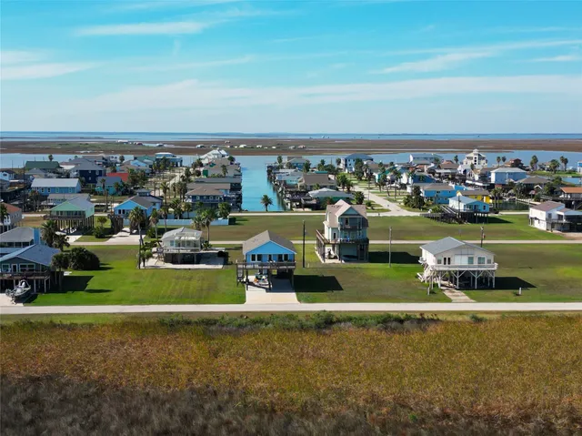an aerial view of a building with lawn chairs and swimming pool