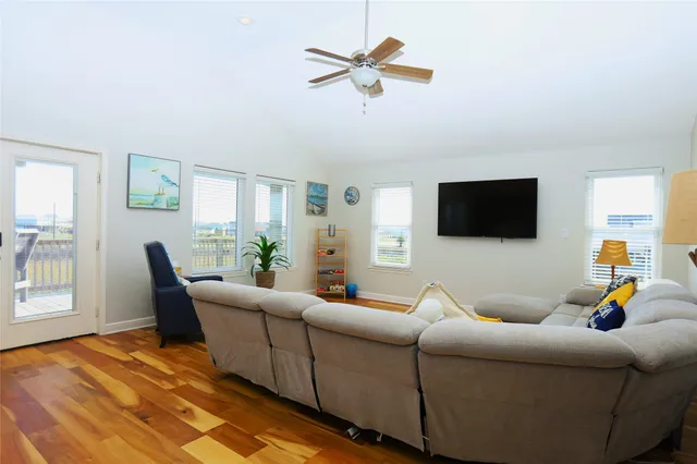 a living room with furniture and kitchen view
