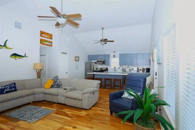 a kitchen with stainless steel appliances a sink a stove a refrigerator cabinets and dining table