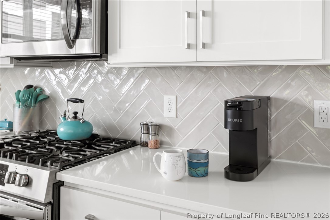 398 Carolina Avenue Raleigh, NC 27606 - Photo 16 of 50 a kitchen with a stove and a refrigerator