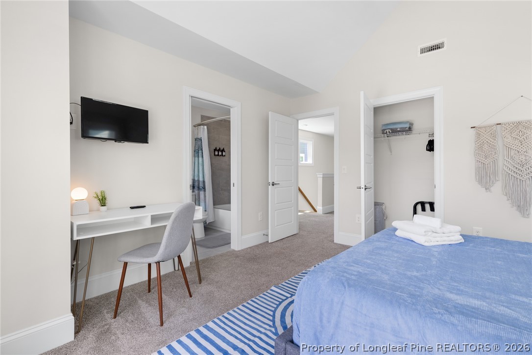 398 Carolina Avenue Raleigh, NC 27606 - Photo 27 of 50 a bedroom with a bed and a flat screen tv