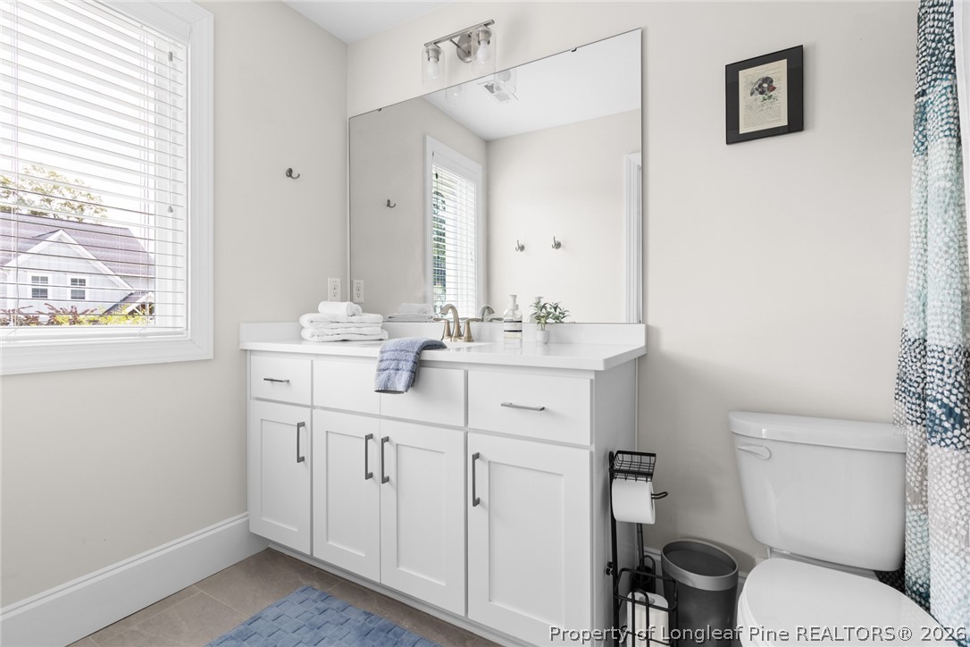 398 Carolina Avenue Raleigh, NC 27606 - Photo 29 of 50 a bathroom with a sink toilet vanity and tub