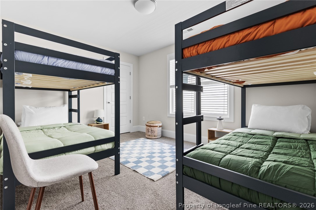 398 Carolina Avenue Raleigh, NC 27606 - Photo 34 of 50 a bedroom with a bed and a table