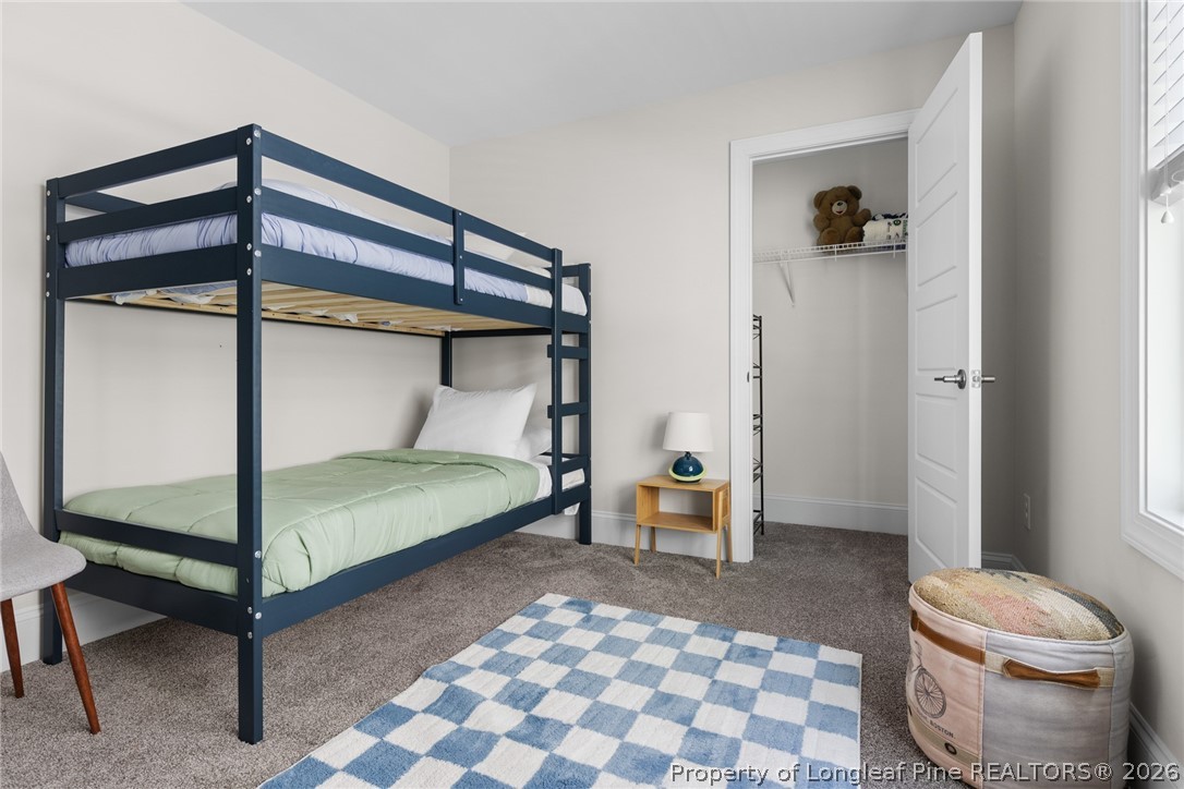 398 Carolina Avenue Raleigh, NC 27606 - Photo 36 of 50 a bedroom with a bed and a mirror