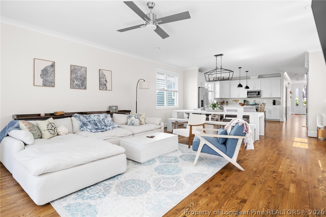 398 Carolina Avenue Raleigh, NC 27606 - Photo 7 of 50 a living room with furniture and a wooden floor
