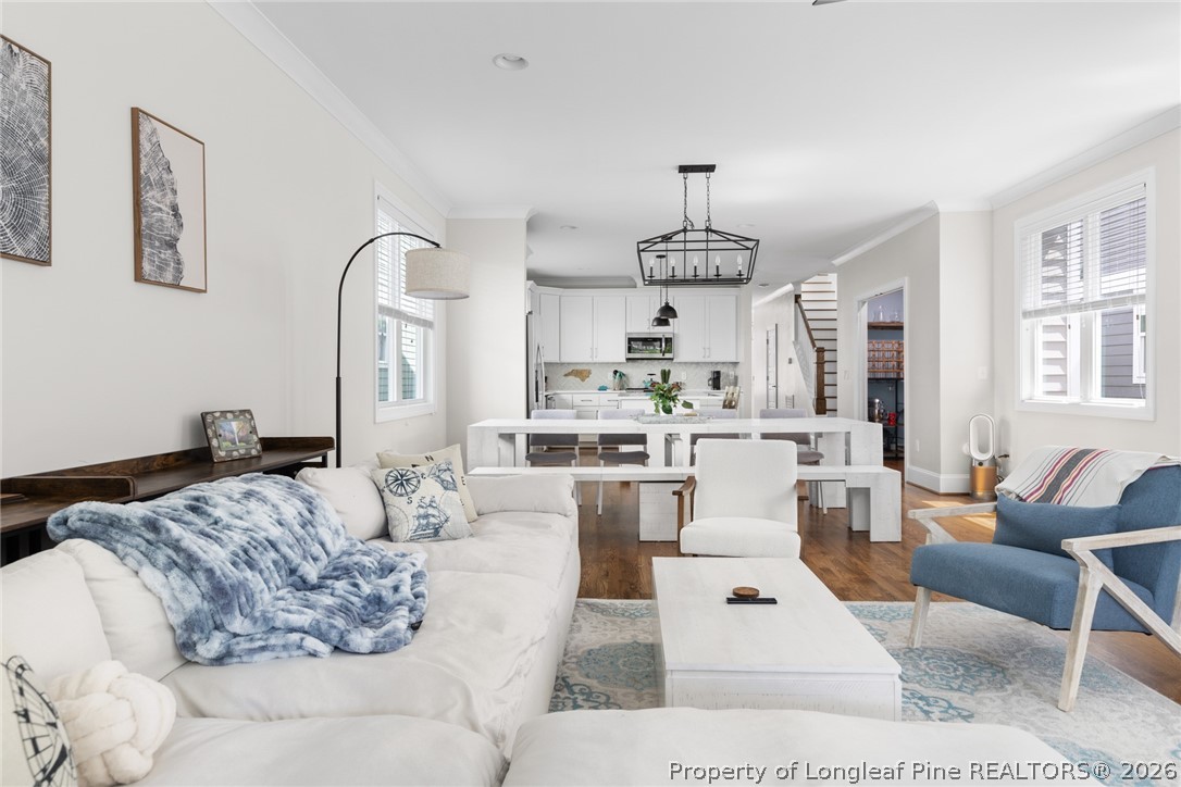 398 Carolina Avenue Raleigh, NC 27606 - Photo 8 of 50 a living room with furniture chandelier and a view of kitchen