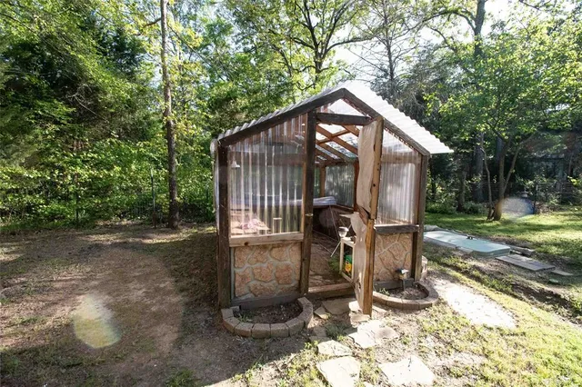 a backyard of a house with barbeque oven and table