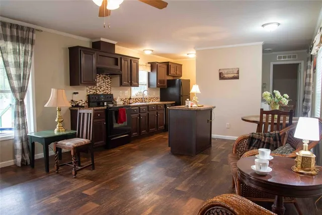 a living room with furniture a dining table and kitchen view