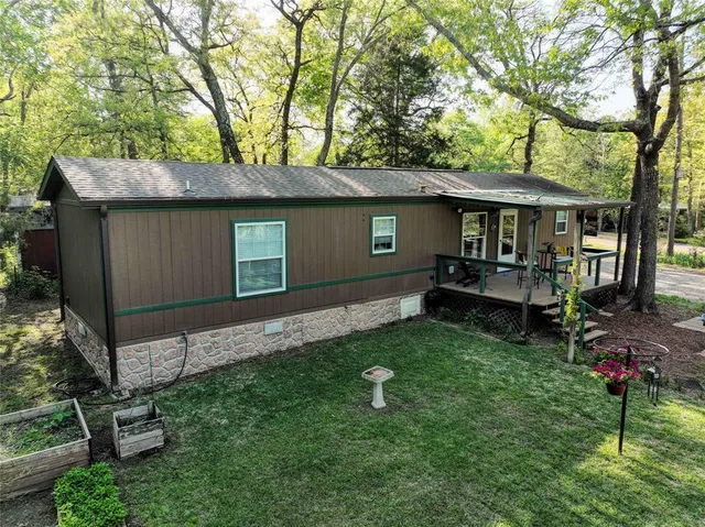 a backyard of a house with barbeque oven table and chairs