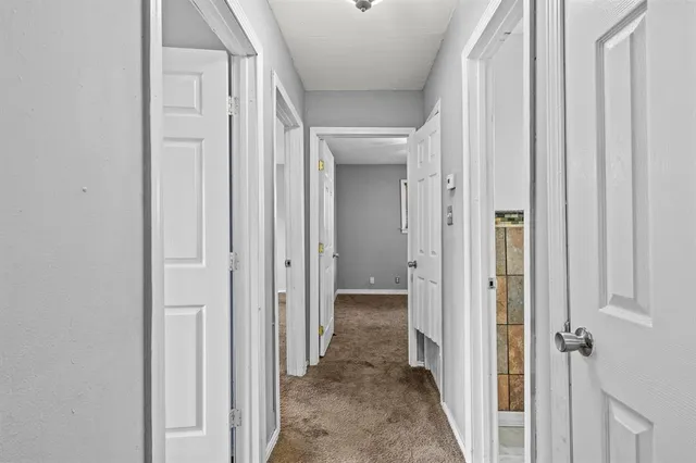 a view of a hallway with a wooden door