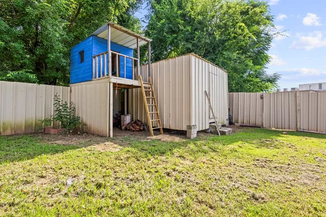 a view of backyard of house with green space