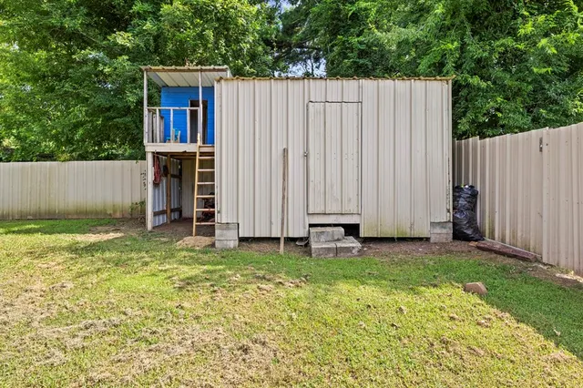 a view of a backyard with a small cabin