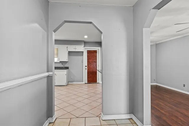 a view of a kitchen with wooden floor and a refrigerator