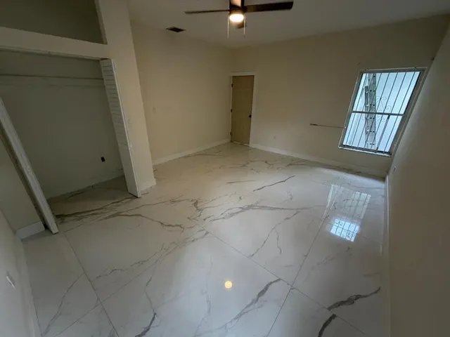 a view of an empty room with a window