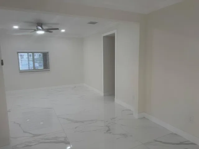 a kitchen with a refrigerator sink and cabinets