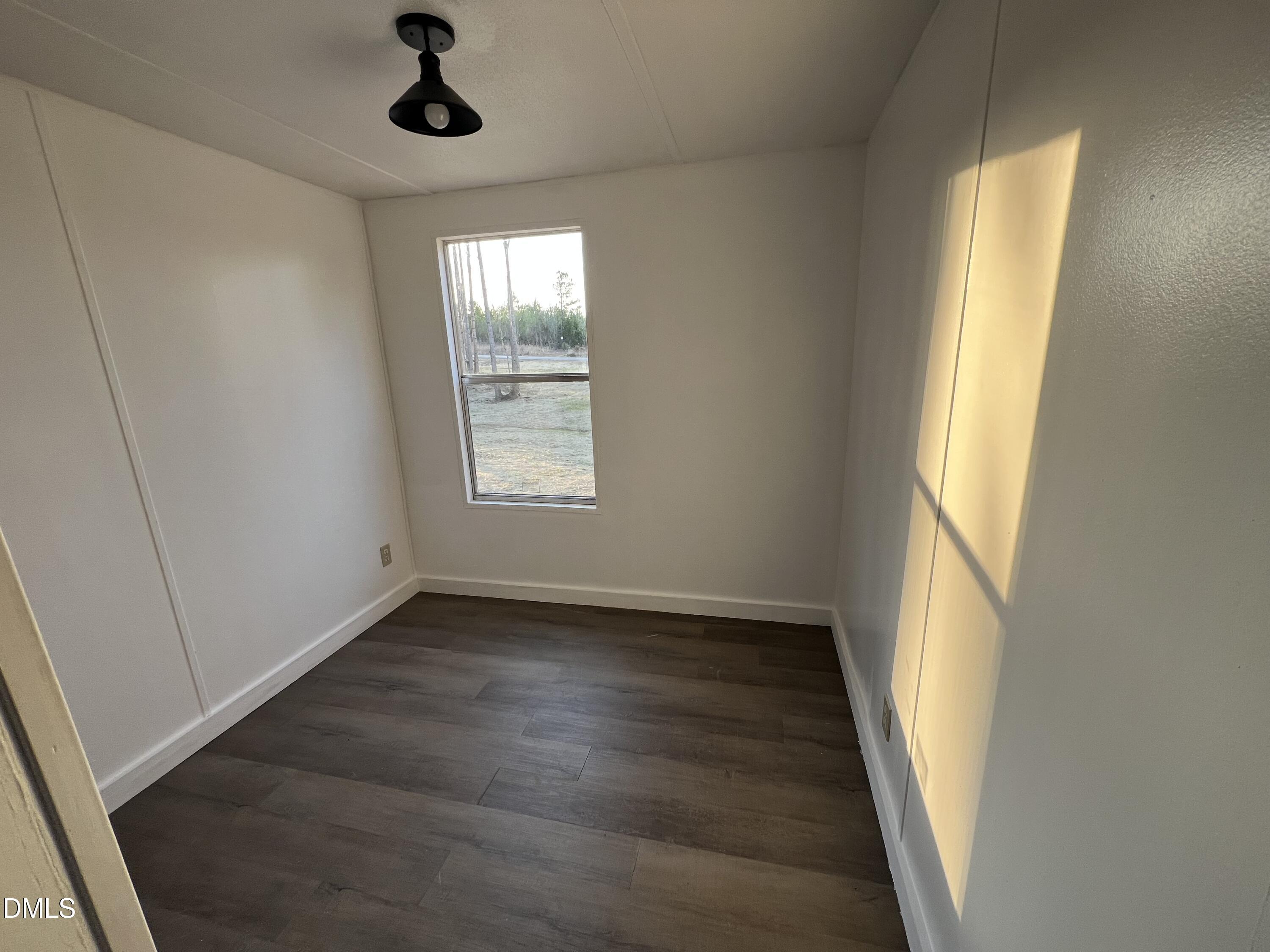 1071 Davis Bugg Road Warrenton, NC 27589 - Photo 13 of 13 an empty room with wooden floor cabinet and windows