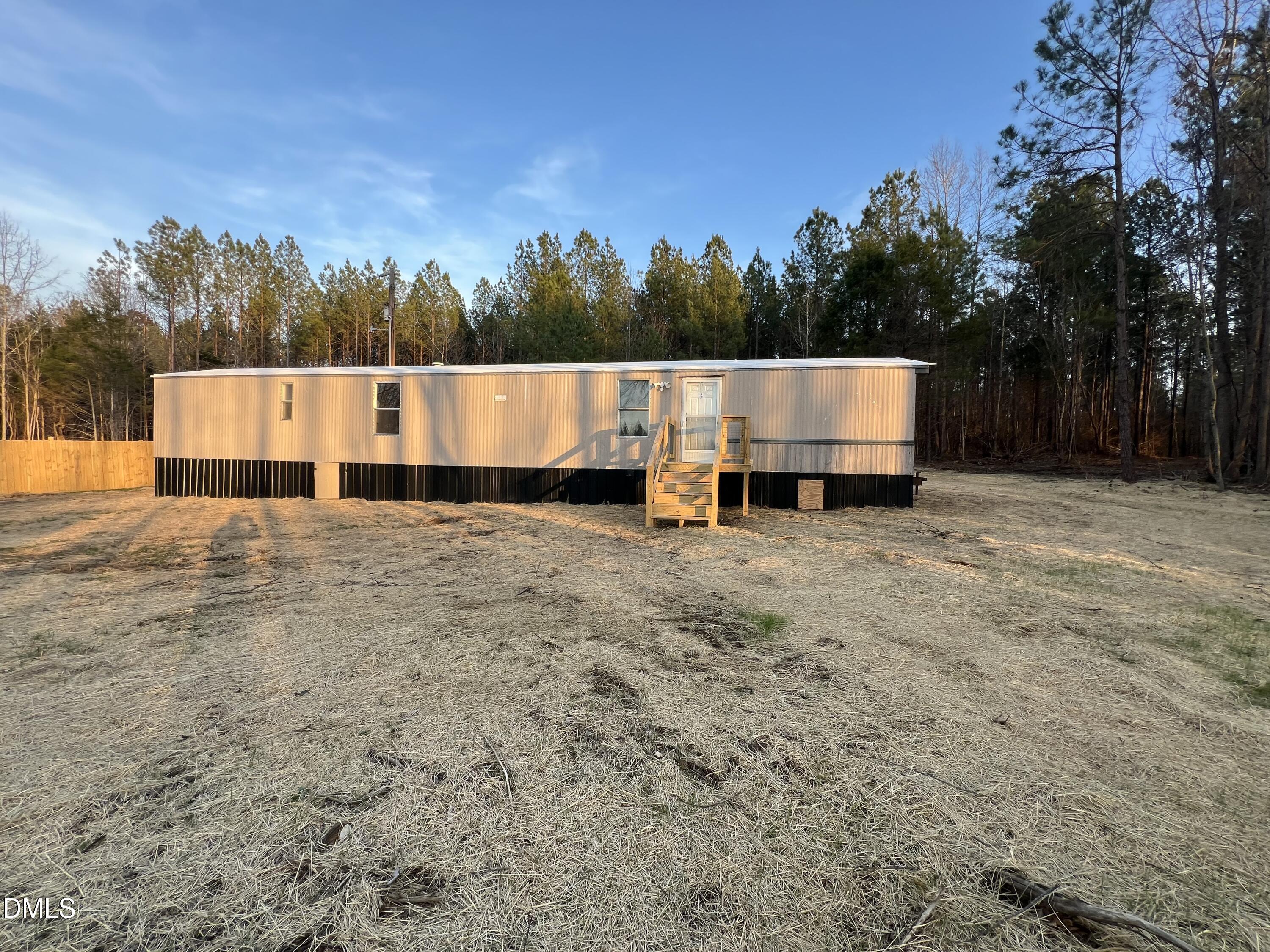 1071 Davis Bugg Road Warrenton, NC 27589 - Photo 3 of 13 a view of a white house with a yard