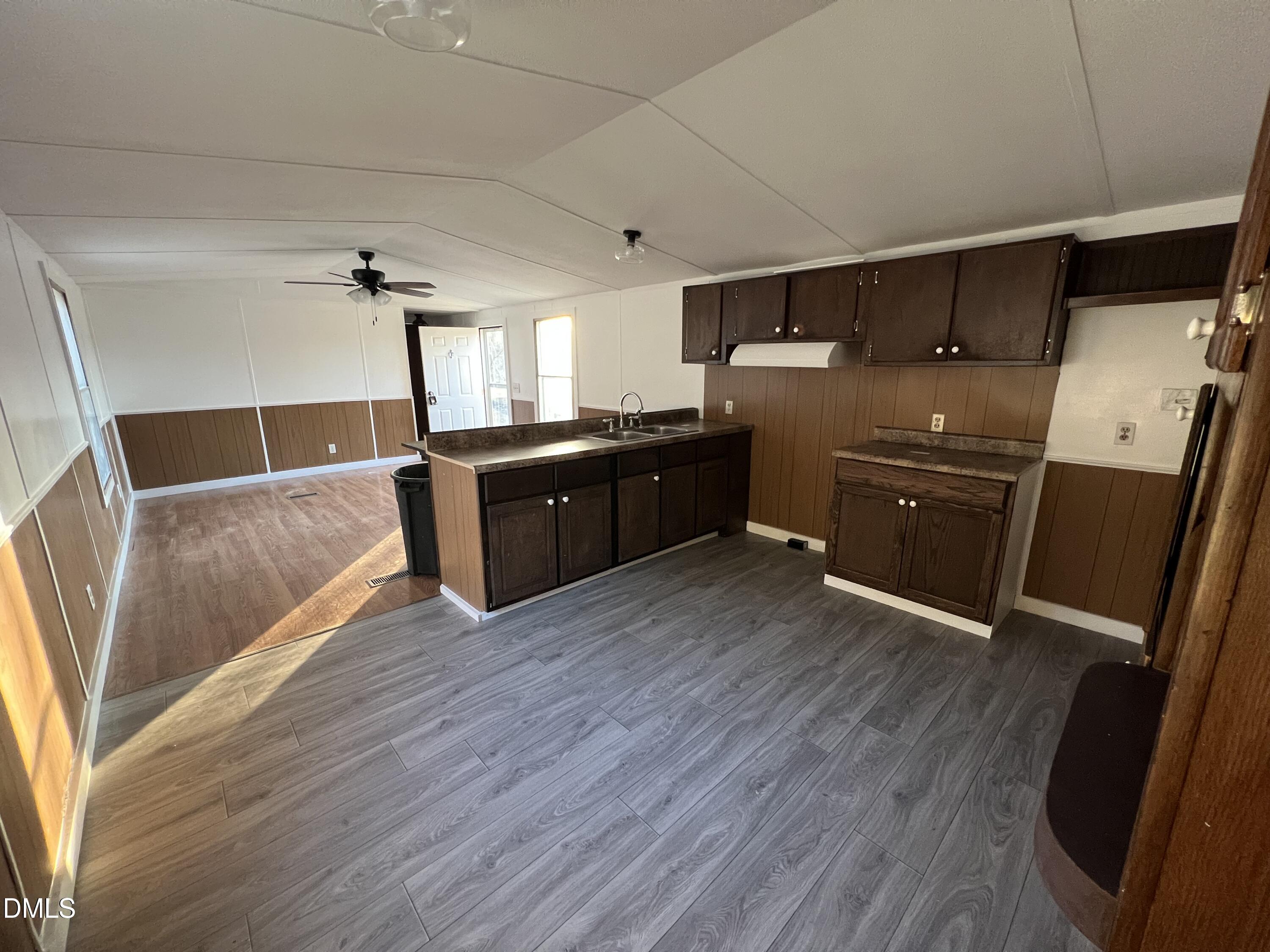 1071 Davis Bugg Road Warrenton, NC 27589 - Photo 8 of 13 a kitchen with stainless steel appliances wooden floors and wooden cabinets