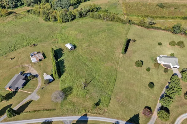 an aerial view of a residential houses with outdoor space