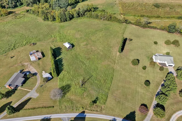 an aerial view of a residential houses with outdoor space