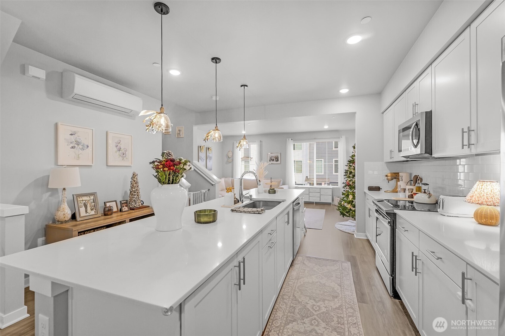 2012 101st Avenue Southeast, Unit 2 Lake Stevens, WA 98258 - Photo 9 of 33 a large kitchen with kitchen island a white counter space a sink a stove and a cabinets