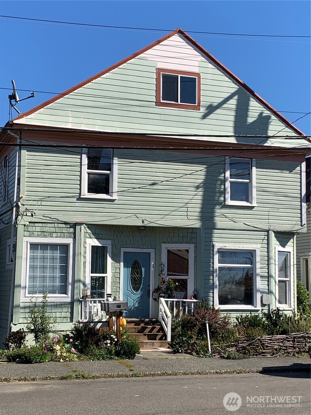 a front view of a house with garage and outdoor seating