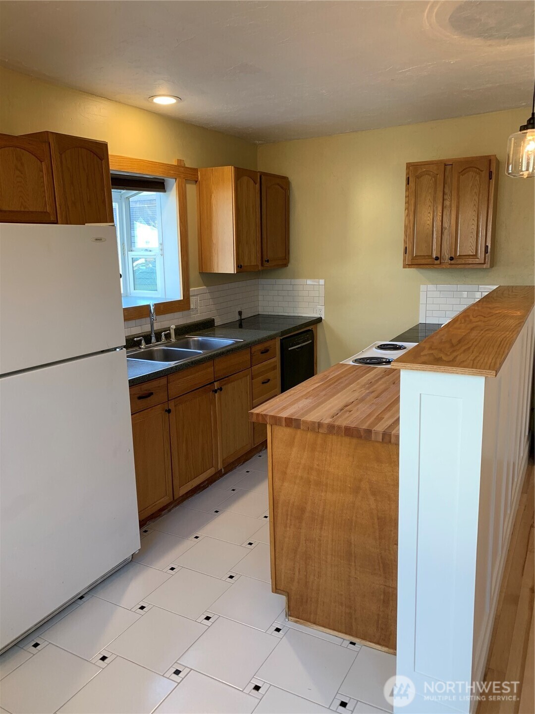316 North F Street Aberdeen, WA 98520 - Photo 29 of 40 a kitchen with stainless steel appliances granite countertop a refrigerator a sink a stove with wooden cabinets