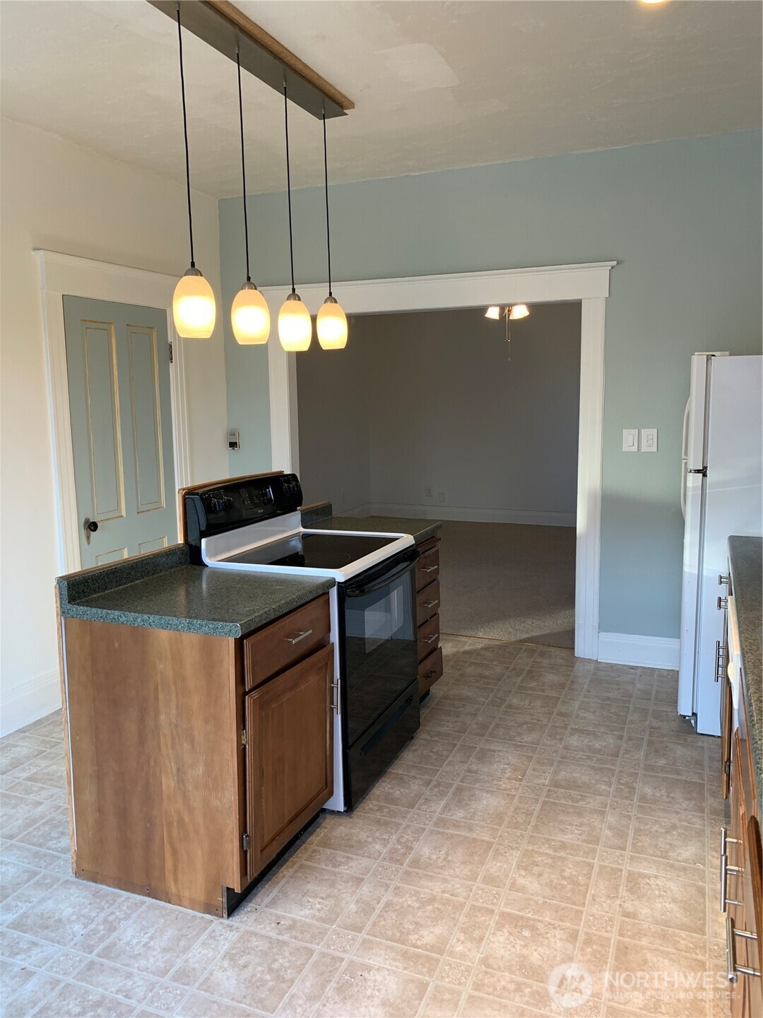 316 North F Street Aberdeen, WA 98520 - Photo 8 of 40 a kitchen with stainless steel appliances granite countertop a sink a stove and a refrigerator