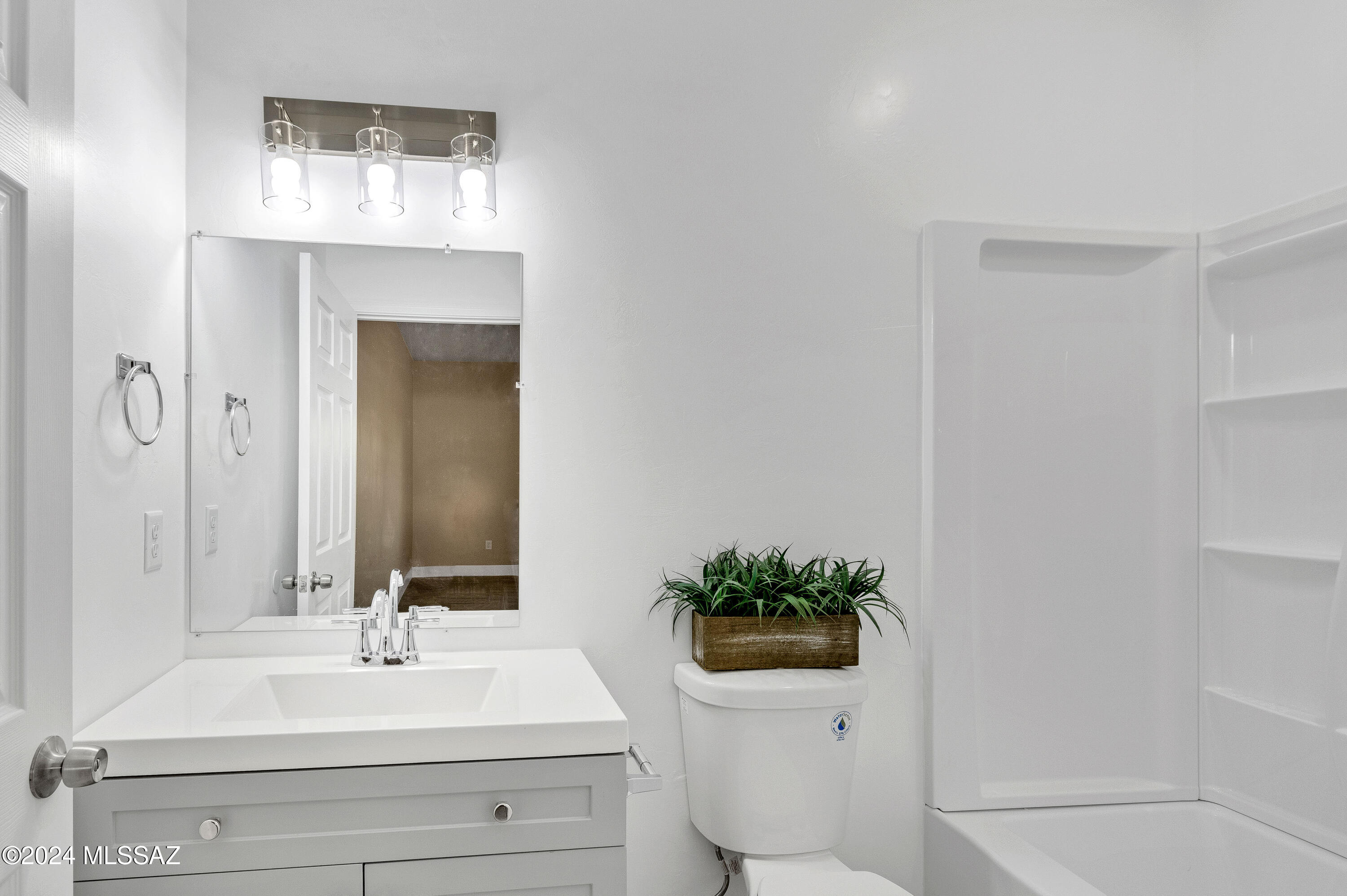 221 Paseo Mascota Rio Rico, AZ 85648 - Photo 21 of 45 a bathroom with a sink a toilet and mirror