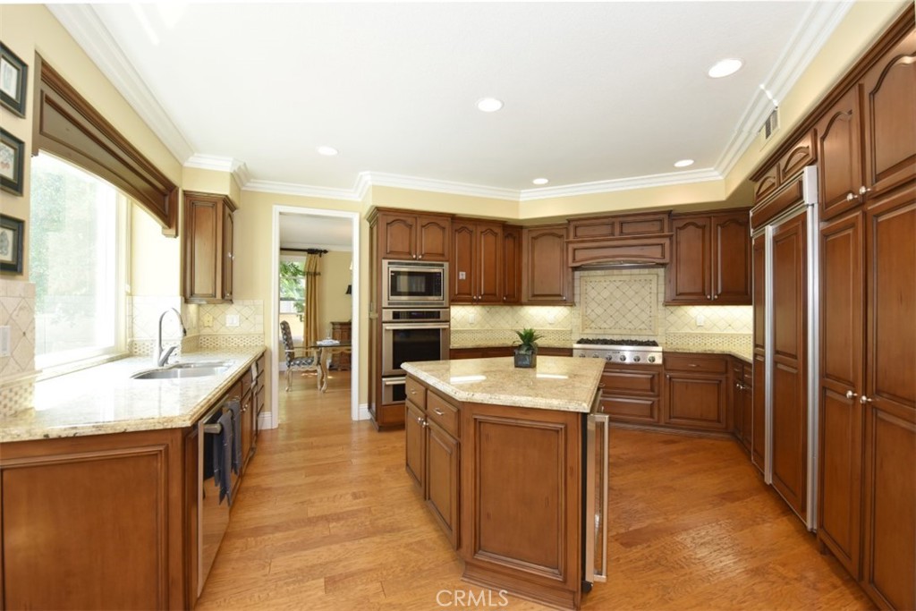 12 Brigadier Irvine, CA 92603 - Photo 23 of 50 a kitchen with granite countertop a sink stove and refrigerator