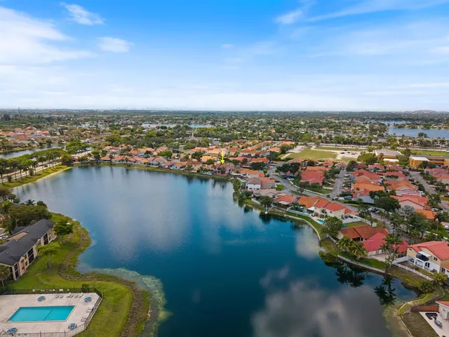 an aerial view of a city with lake view in back