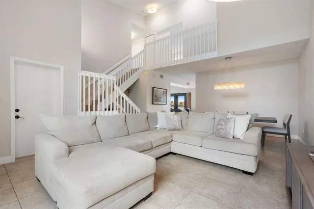 a living room with furniture a ceiling fan and a rug