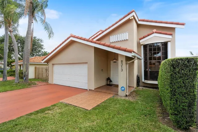 a front view of house with yard and green space