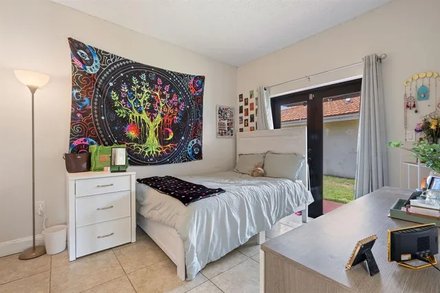 a bedroom with a bed and a wall painting