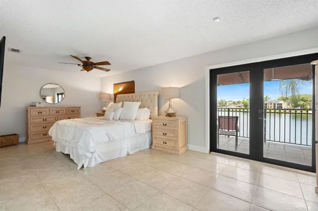 a bed room with a bed and a large window