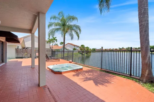 a view of a house with backyard porch and sitting area