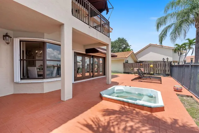 a view of a patio with swimming pool table and chairs