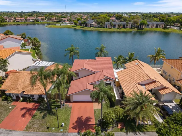 an aerial view of a house with a lake view