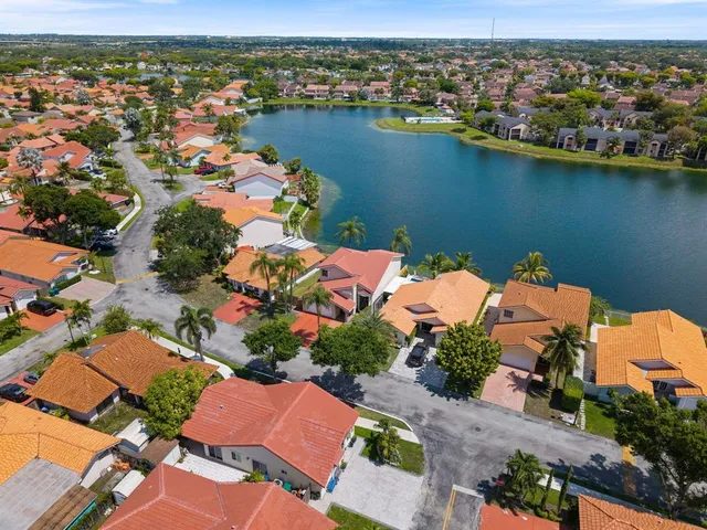 an aerial view of lake and residential houses with outdoor space