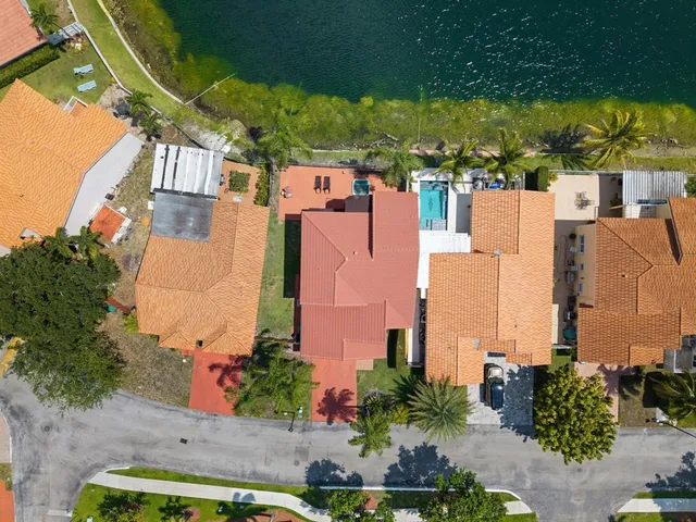 an aerial view of residential houses with outdoor space and swimming pool