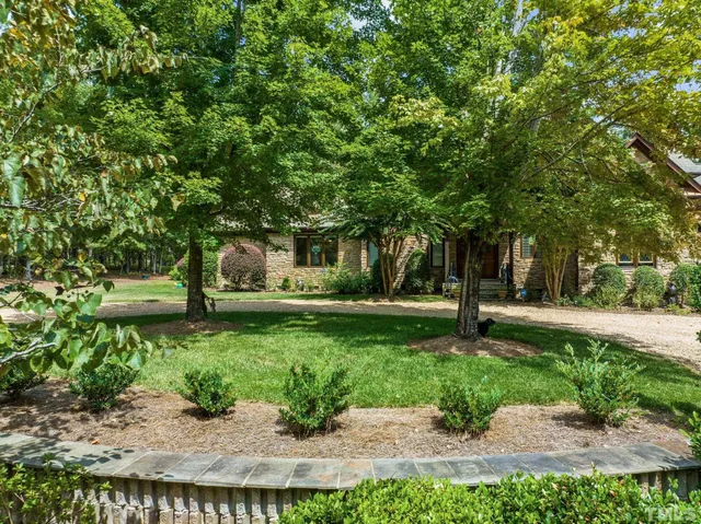 a view of a hallway to a livingroom with furniture