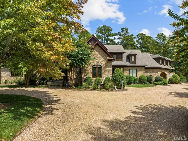 a living room with furniture a dining table and a piano next to a large window