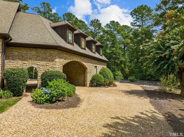 a living room with fireplace furniture and a chandelier