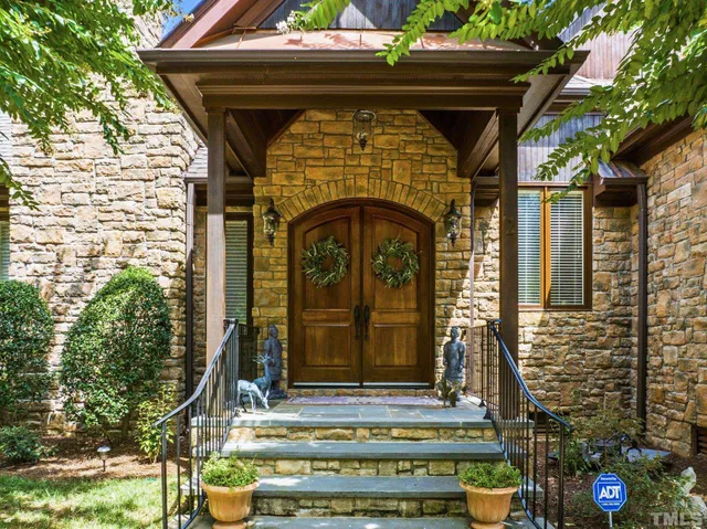 a living room with furniture or chandelier and a wooden floor