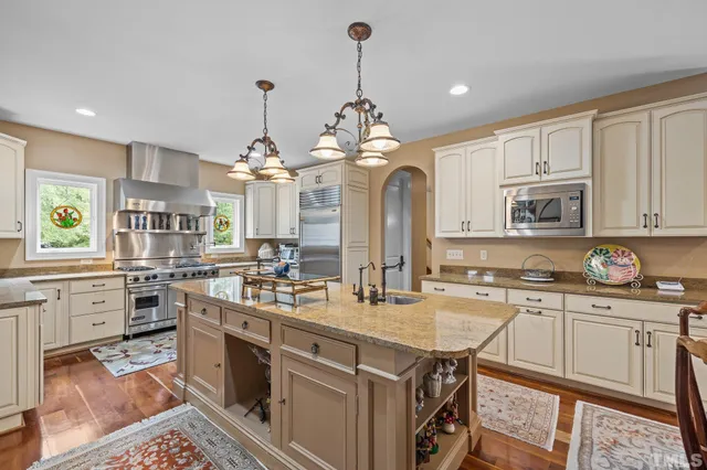 a bed room with a bed a couch and a large window