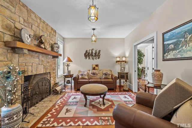 a view of a livingroom with furniture wooden floor and windows