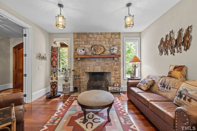 a living room with furniture and a chandelier